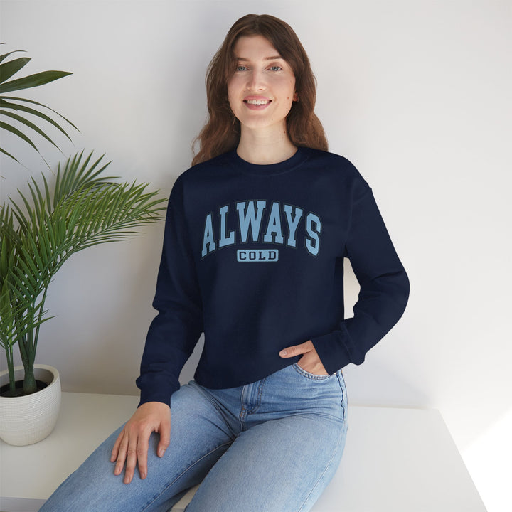 Always Cold Varsity Graphic Sweatshirt by Printify featuring bold lettering and a cozy, casual design.