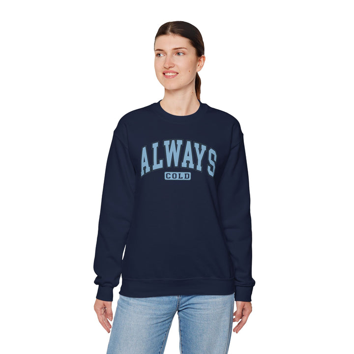 Always Cold Varsity Graphic Sweatshirt by Printify featuring bold lettering and a cozy, relaxed fit in a stylish design.