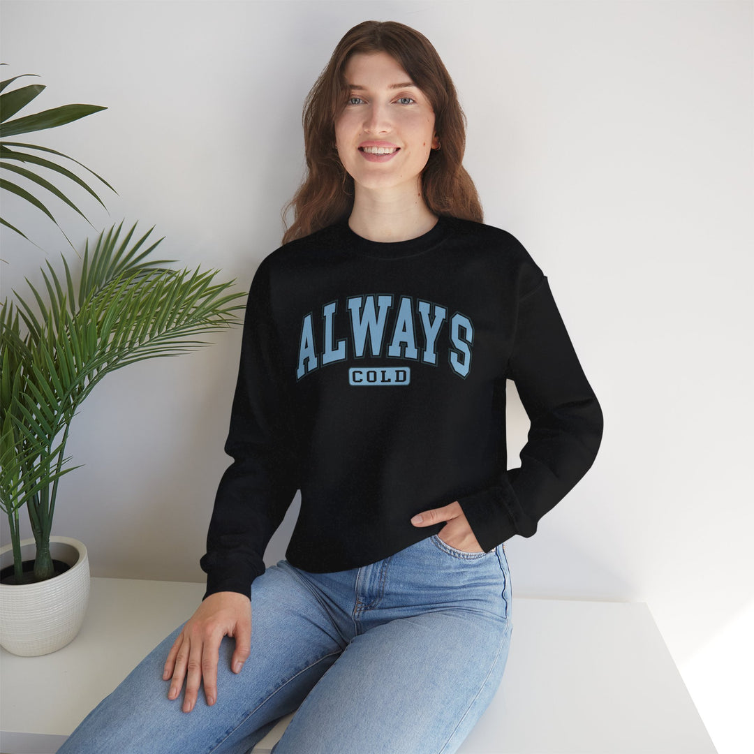 Always Cold Varsity Graphic Sweatshirt by Printify featuring a bold graphic design and comfortable fit in a casual setting.