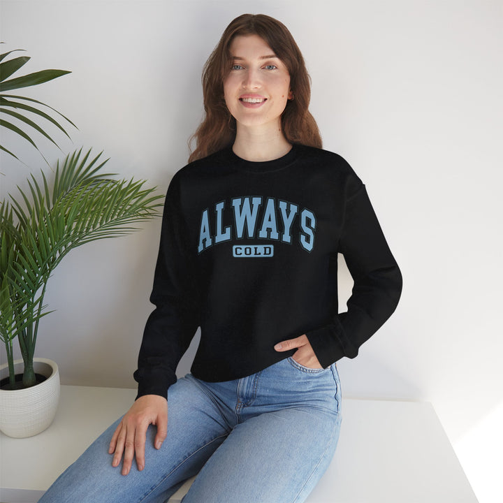 Always Cold Varsity Graphic Sweatshirt by Printify featuring a bold graphic design and comfortable fit in a casual setting.