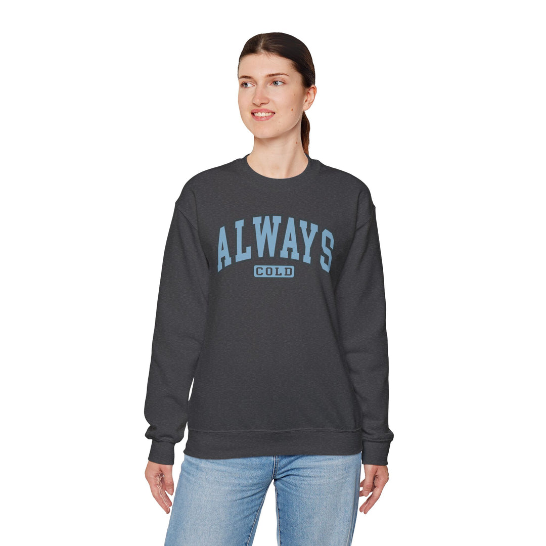 Always Cold varsity graphic sweatshirt by Printify, featuring bold lettering and a cozy design in a casual setting.